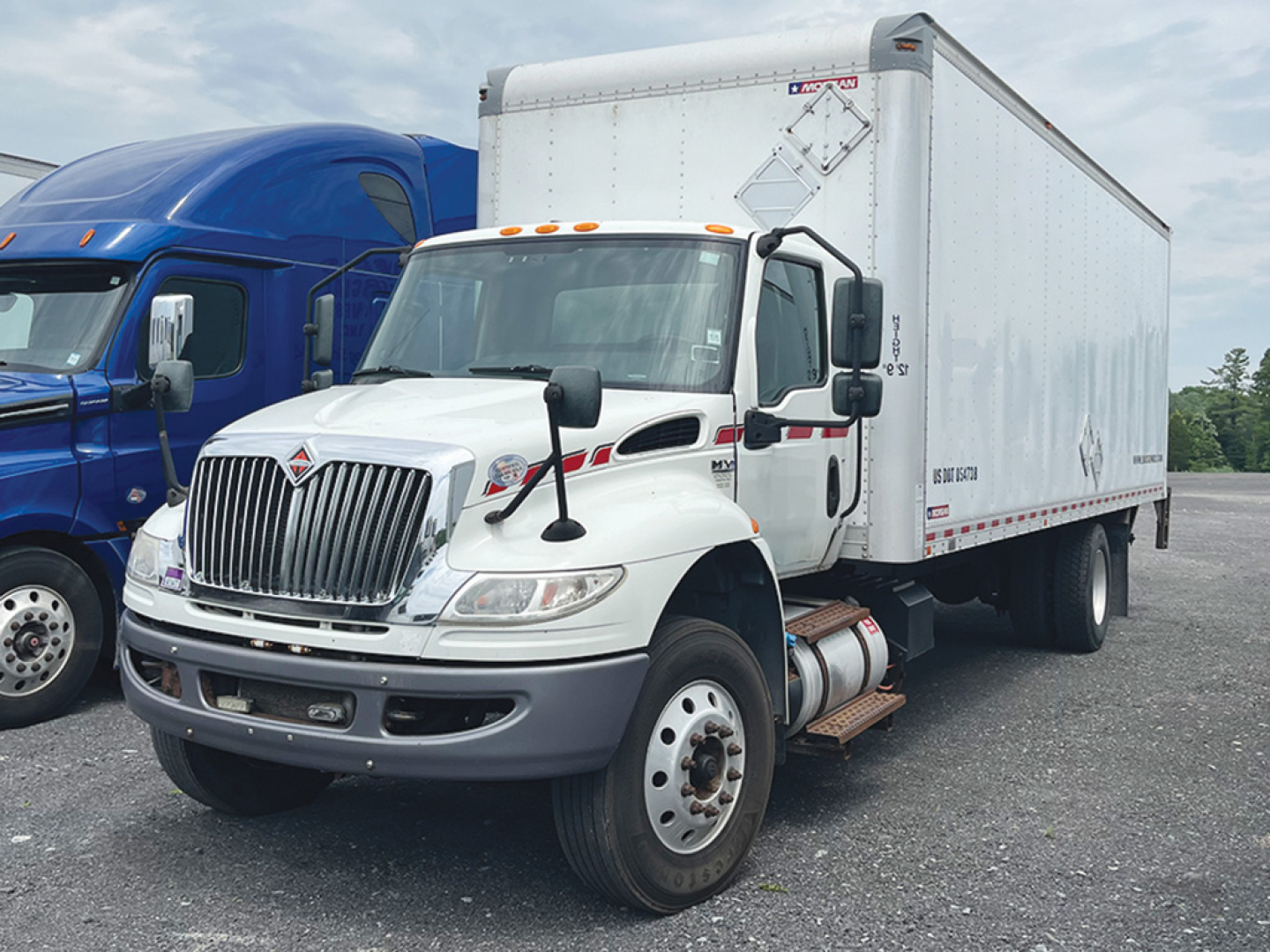 Truck cab and box truck in a used vehicle lot, 2020 International MV607 with white cab and large rectangular box