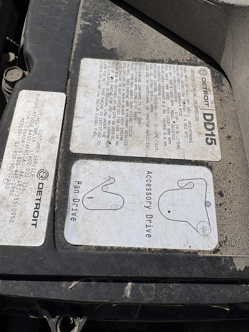 Label stickers on a Freightliner CASCADIA 126 engine bay; includes Detroit Diesel DDDL label and Fan Drive annotations with text blocks and diagrams.