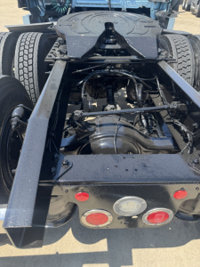 Rear view of a Freightliner Cascadia 126 tractor chassis showing drivetrain components and rear lights.