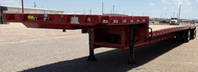 Trailer side profile showing a red 53' spread drop deck trailer with landing legs extended, multiple warning labels, and low-profile frame.