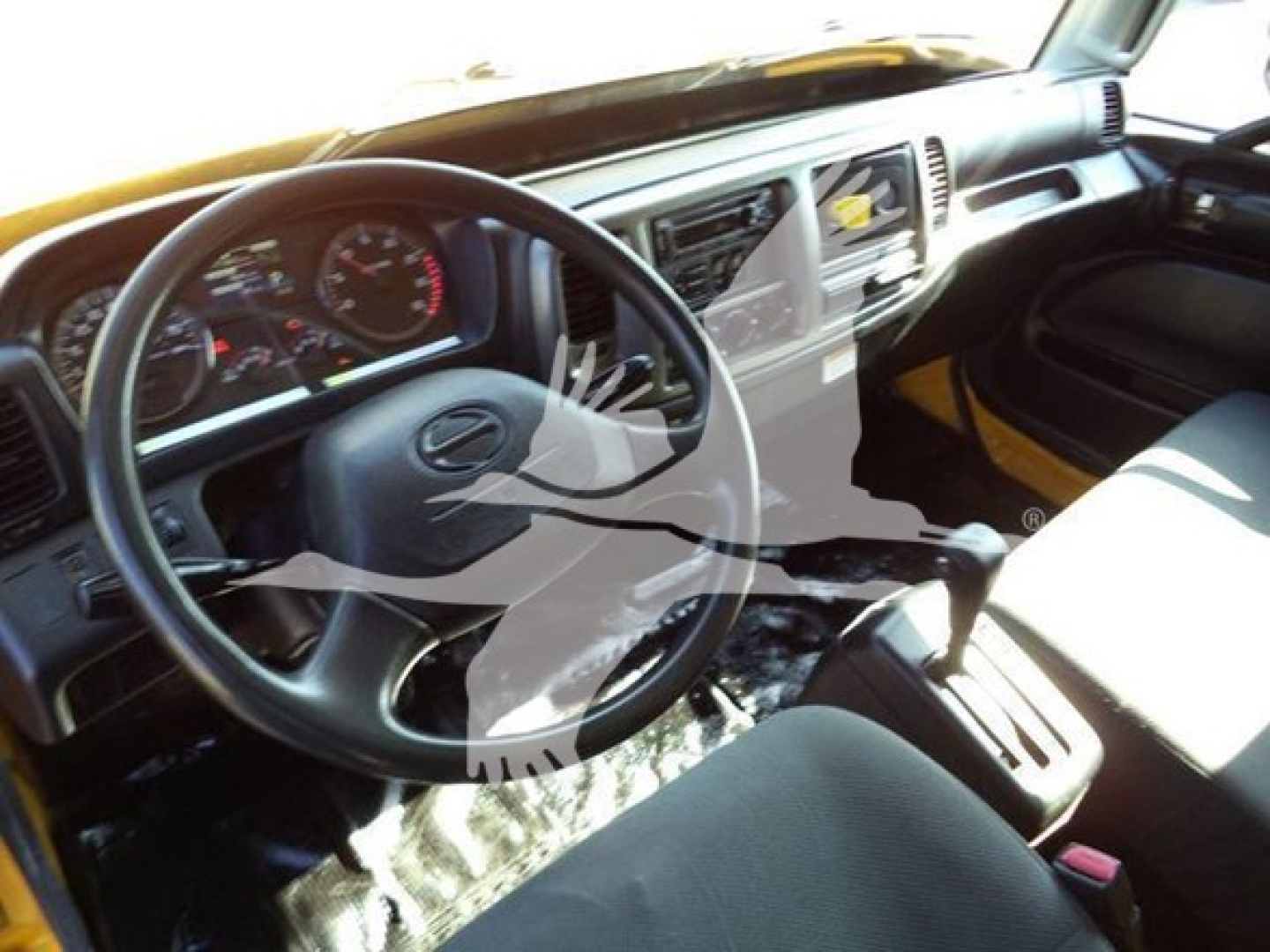 Cab interior of a 2019 Hino 268A shows steering wheel, dashboard with gauges, center console, and driver seat.