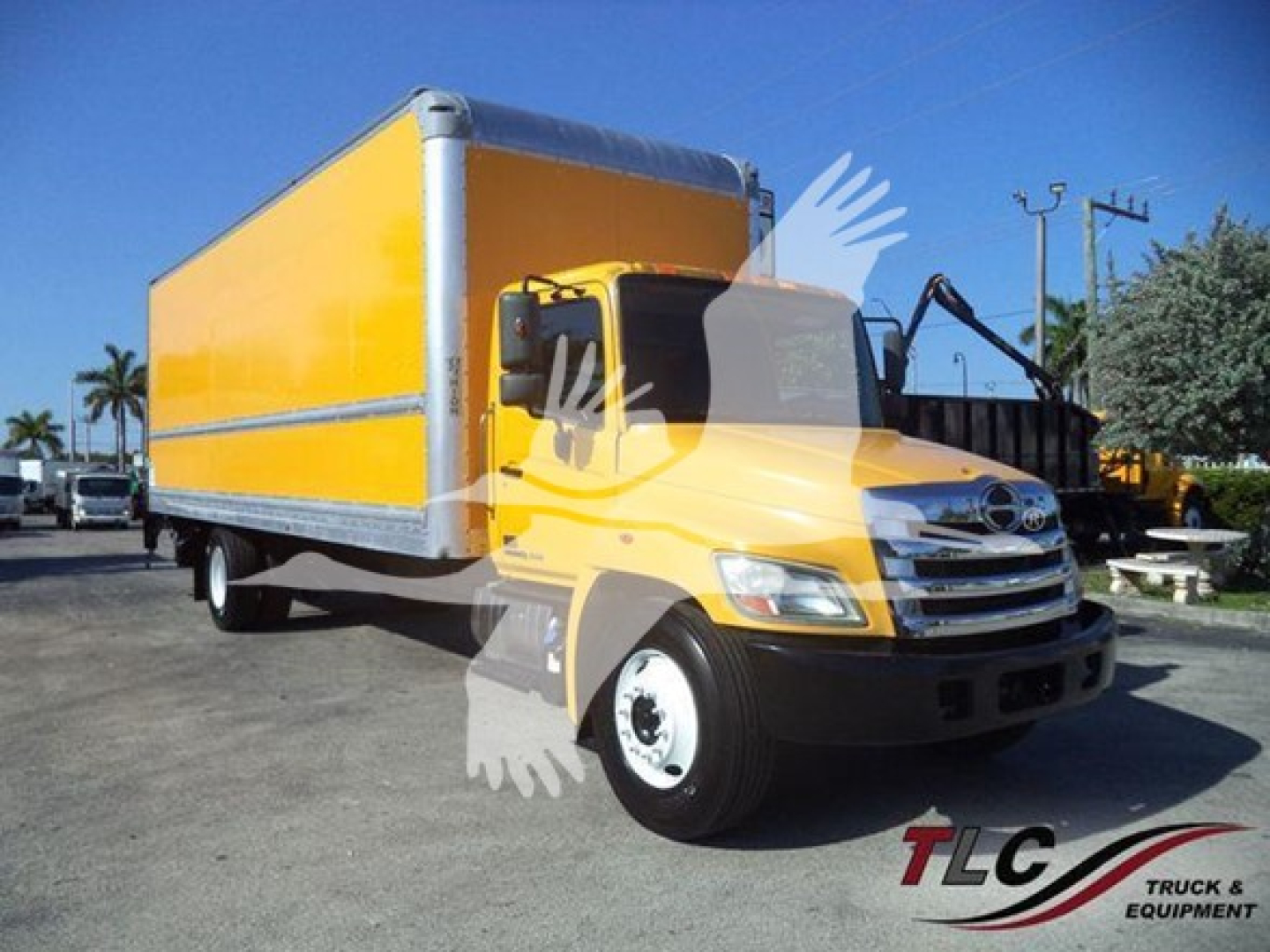 Box truck 2019 Hino 268A side view showing bright yellow cab and cargo box with chrome grille and black bumper.