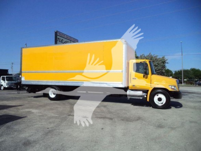 Box truck side view showing bright yellow cargo box and cab with Hino-style grille, 2019 Hino 268A, stock and VIN notations visible in context.