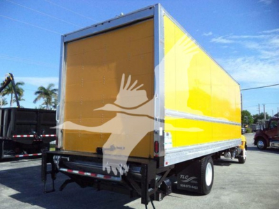 Hino 268A box truck showing bright yellow cargo body with silver framing, side view.