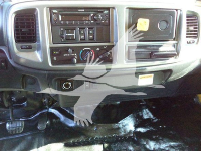 Dashboard and center console of a 2019 Hino 268A cab showing steering column controls, radio, A/C controls, and ignition area.