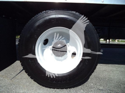 Truck wheel close-up showing tire and white steel rim; no visible text legible on tire.