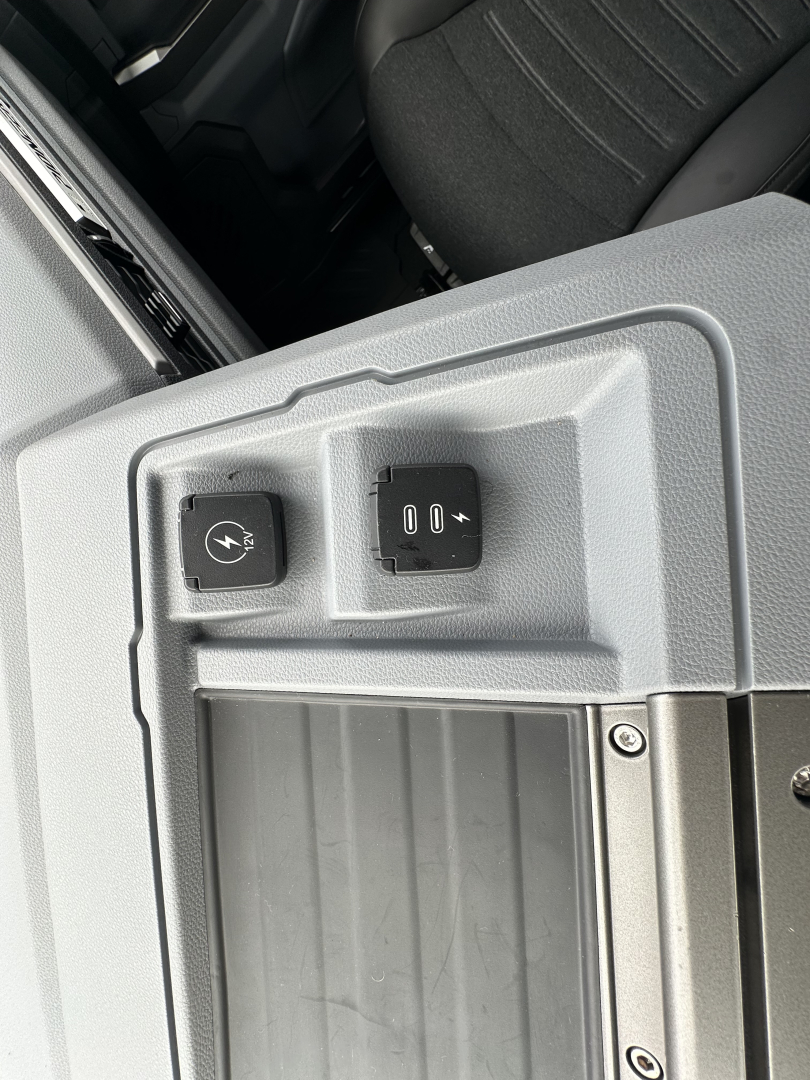 Cab interior window switch area with two knobs visible on a Mack PR64T76H truck cab door panel.