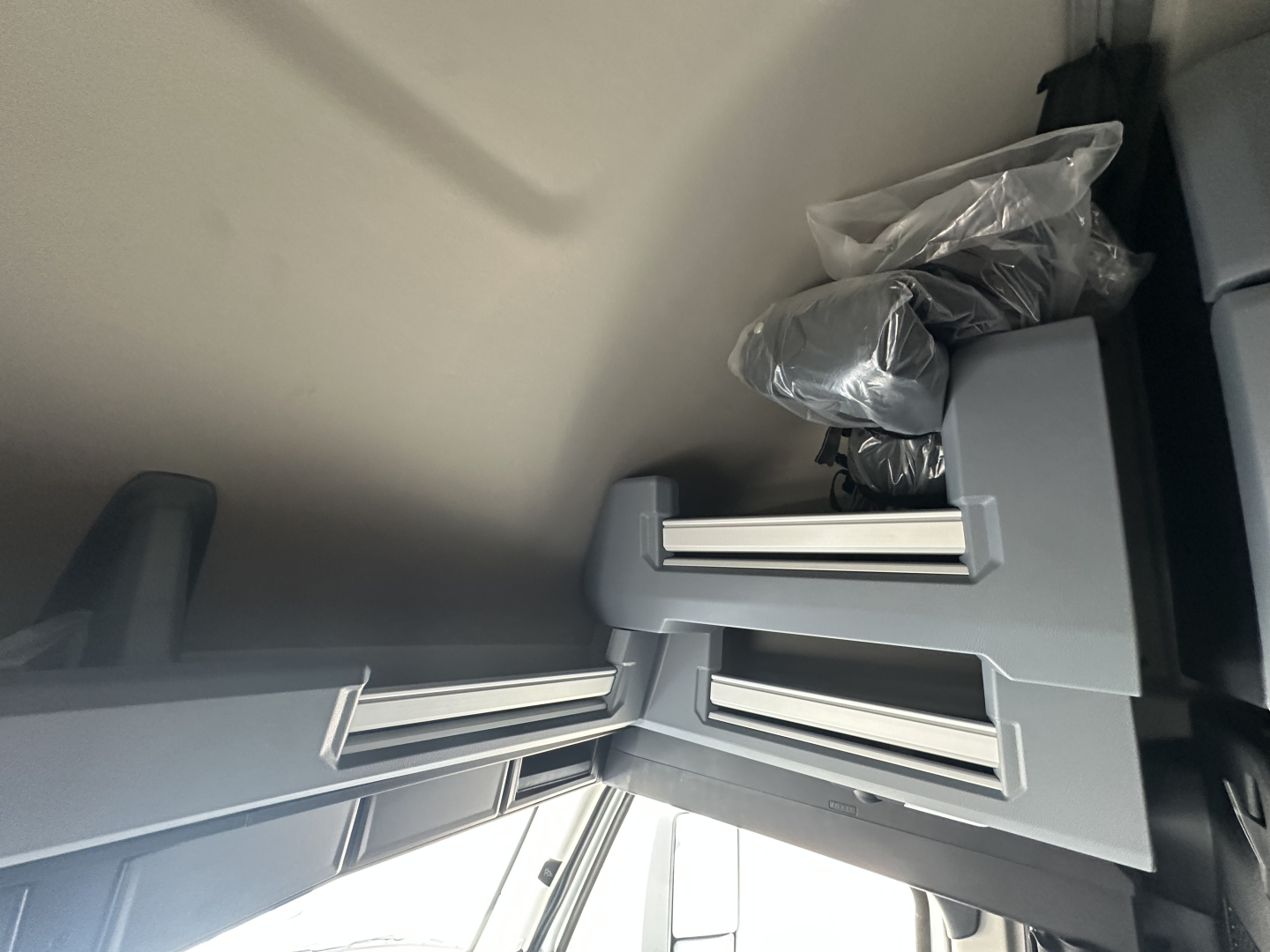Truck cab interior showing storage compartments and overhead shelves in a Mack PR64T76H.