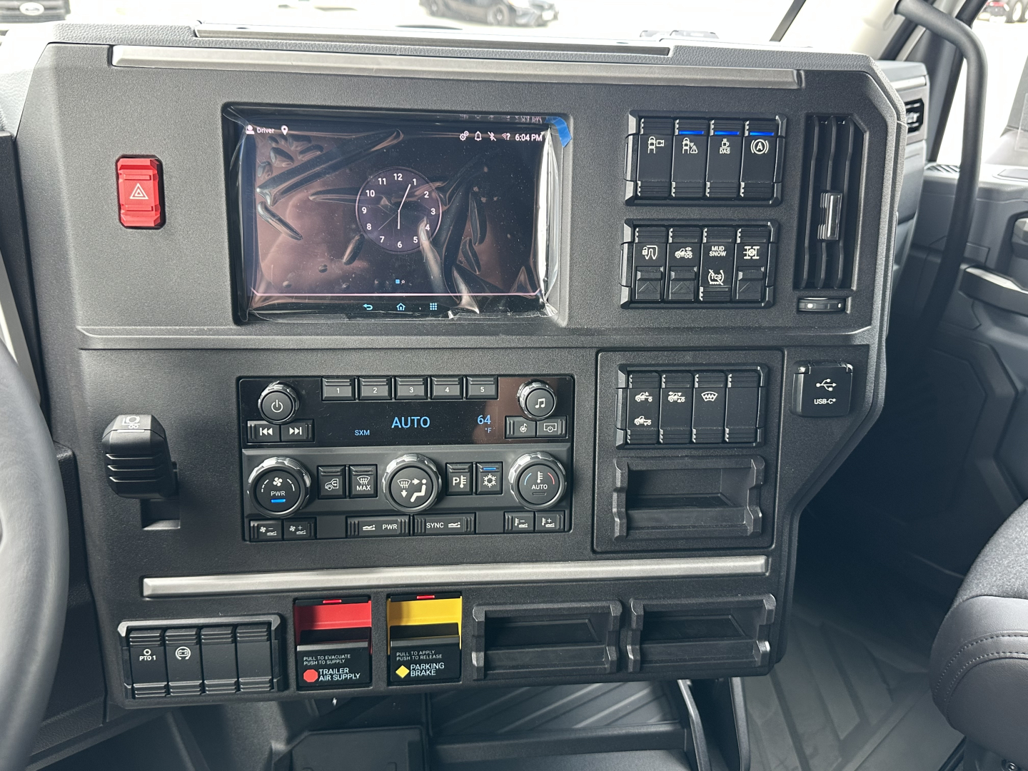 Mack PR64T76H truck dash interior showing instrument cluster, climate controls, and various switches.