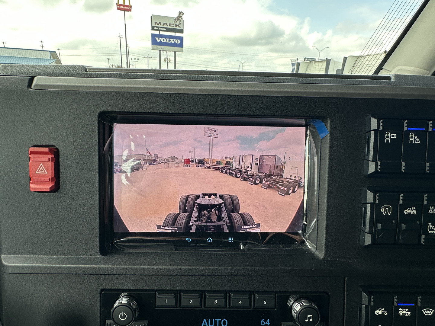 Dashboard view showing rearview camera display in Mack PR64T76H truck cab.