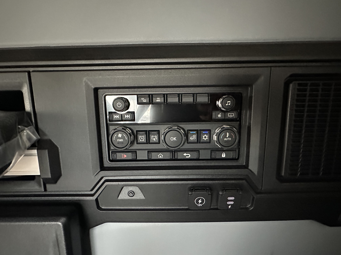 Truck interior control panel showing climate and media controls in a Mack PR64T76H dash view.