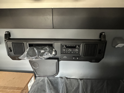 Mack PR64T76H truck cabin dash area with center console and controls.