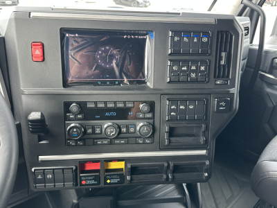 Mack PR64T76H truck dash interior showing instrument cluster, climate controls, and various switches.