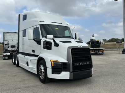 Mack PR64T76H conventional sleeper truck in white front-side view showing grille and cab details.