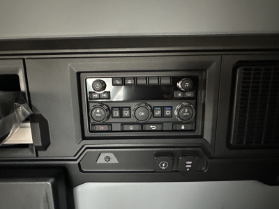 Truck interior control panel showing climate and media controls in a Mack PR64T76H dash view.