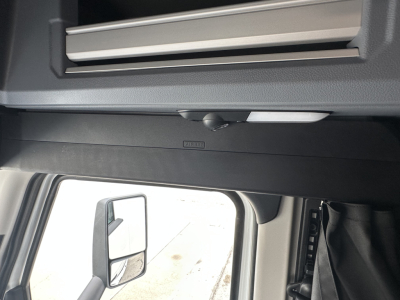 Mack PR64T76H truck interior roof area with overhead storage and sun visor showing hood release handle