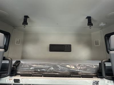 Mack PR64T76H sleeper cab interior with bunk area and overhead straps