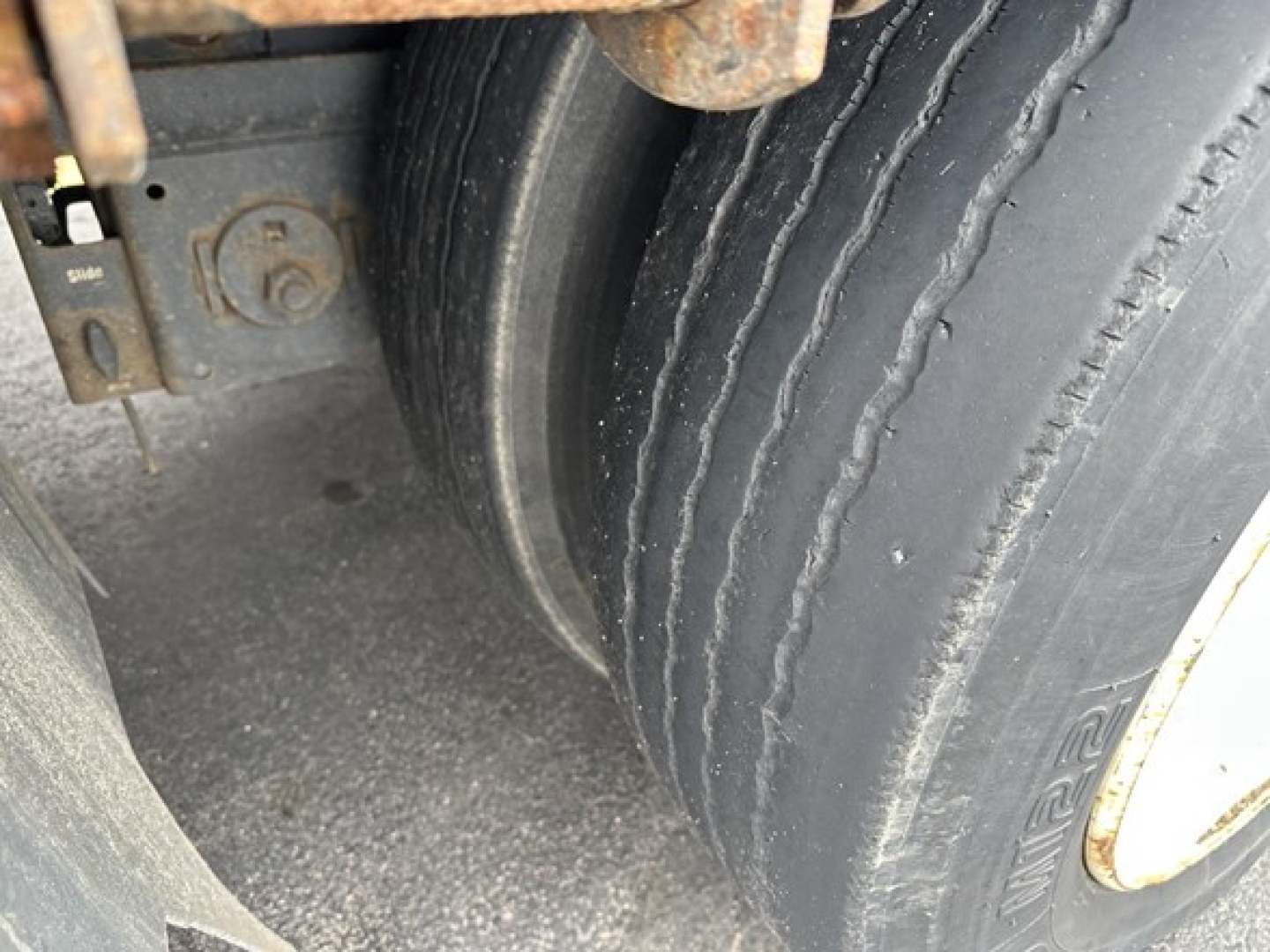 Trailer wheel area of a 2019 Fontaine 53' combo drop deck showing dual tires and rim, part of rear slide axle assembly.