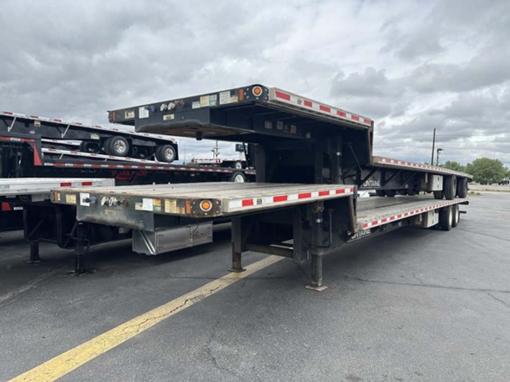 2019 Fontaine 53' combo drop deck trailer with rear slide axle, viewed from rear side showing metal frame, ramps, and support legs.
