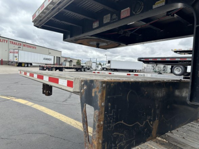 Trailer showing rear slide axle on a 2019 Fontaine 53' combo drop deck with open underside and rusted metal edge.