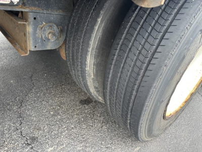 Trailer wheel and tire close-up showing dual rear axle with lug nut and mounting hub in a Fontaine logistics trailer context.