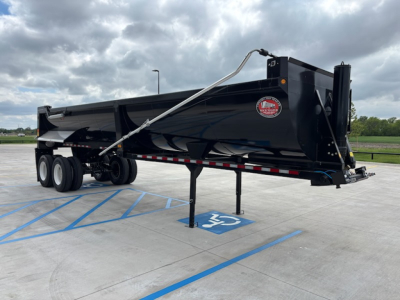 Dump trailer showing black CTS 32'/48' HRD model with dual axles, hydraulic landing gear, and safety chain in parking lot.