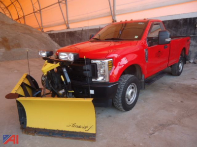 Red 2019 Ford F-350 Super Duty pickup with yellow plow attached in an indoor lot; 4x4, crew cab, snow plow ready.