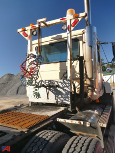 Truck cab of a 1995 Mack CH613 tractor showing rear view with hoses and bumper details.