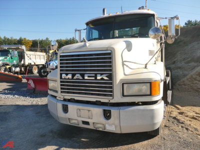 Mack CH613 tractor truck front view showing large grille with MACK logo, daytime cab, white exterior, bumper and headlights visible.