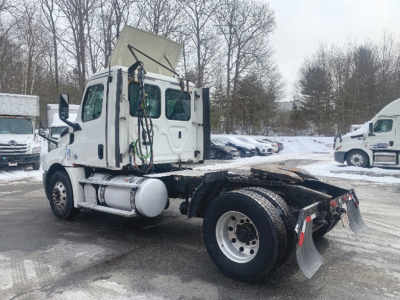 Freightliner Cascadia 126 truck chassis side view with sleeper cab, white exterior, snow on ground.