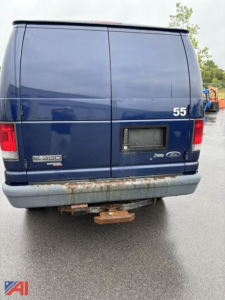 Ford E-350 cargo van rear view showing model badge and bumper with hitch, blue paint, number 55, and rear doors.