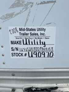 Label on utility trailer showing 2008 Mid-States Utility Trailer Sales, Inc. with S/N UYVS25388P353153 and Stock U90970.