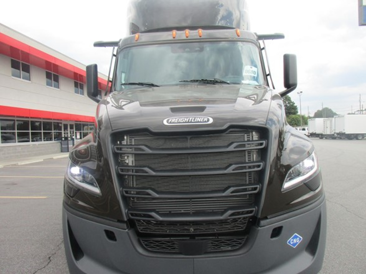 Freightliner Cascadia 126 front view showing bold grille, headlights, and tall sleeper cab in-vehicle bay, with brand badge and aerodynamic design.