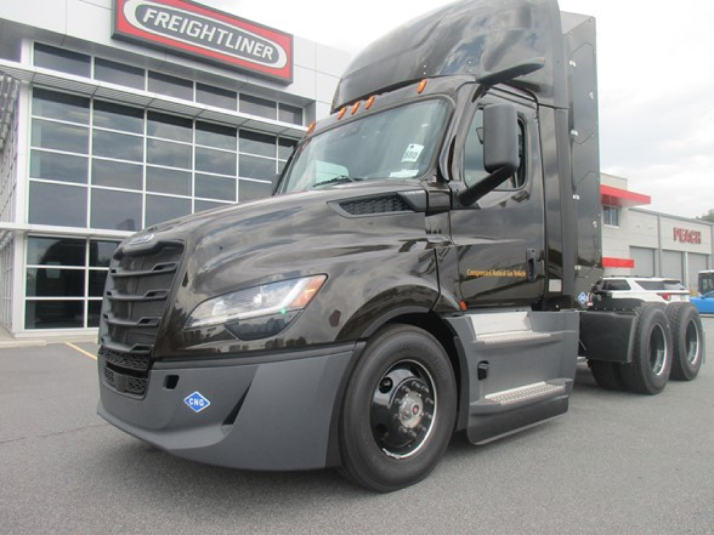 Freightliner Cascadia 126 Day Cab truck in front of dealership showing cab and front wheel, VIN plate not visible, stock number 331205.