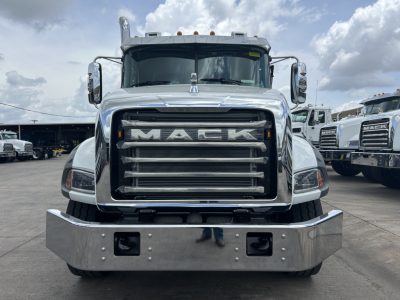 Front view of a new 2027 Mack GR64B roll-off truck showing large chrome grille with MACK lettering and chrome bumper.