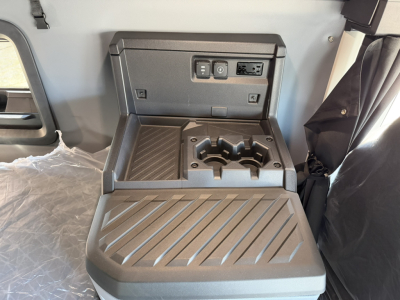 Mack PR64T76H truck interior center console with cupholders and control panel.