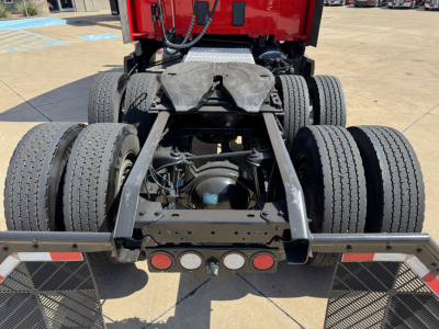 Kenworth T680 rear view showing fifth wheel, suspension, and dual rear axles with tires.
