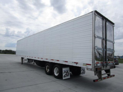 Utility refrigerated trailer with white side panels, dual rear doors, three-axle setup with two tires on each side visible; rear bumper and mudflaps display '25' placards.