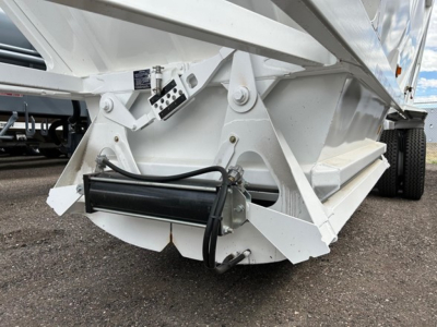 Trailer component with hydraulic cylinder and support frame showing undercarriage of a white dump trailer