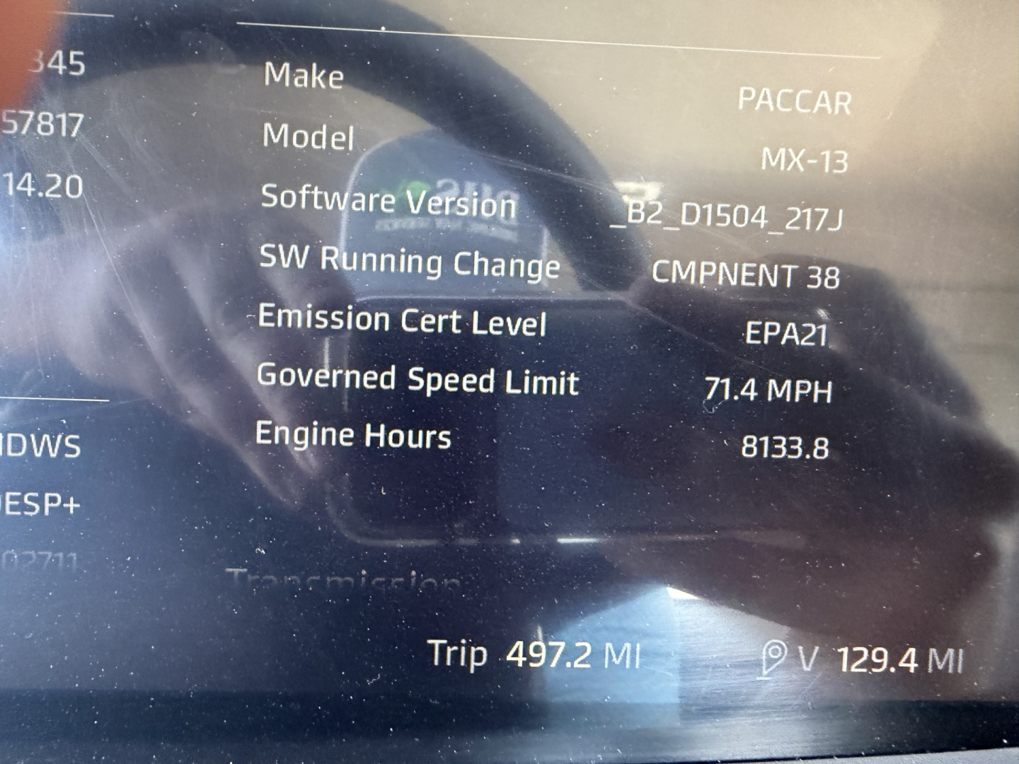 Dashboard screen of a 2023 Kenworth T880 showing vehicle software and engine data, including Make PACCAR, Model MX-13, Emission Cert Level EPA21, Speed Limit 71.4 MPH, Engine Hours 8133.8, Trip 497.2 MI, VIN and stock number partially visib