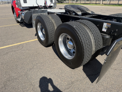 Trailer chassis showing dual rear axles with tires and rims on a Kenworth T880 semi-truck chassis.