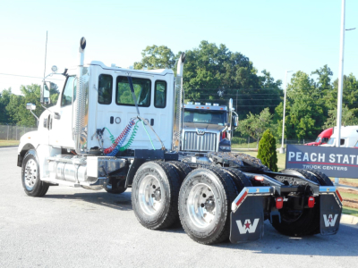 White Western Star 49X truck tractor side view showing dual rear axles and fifth wheel, cab with chrome exhaust stacks.