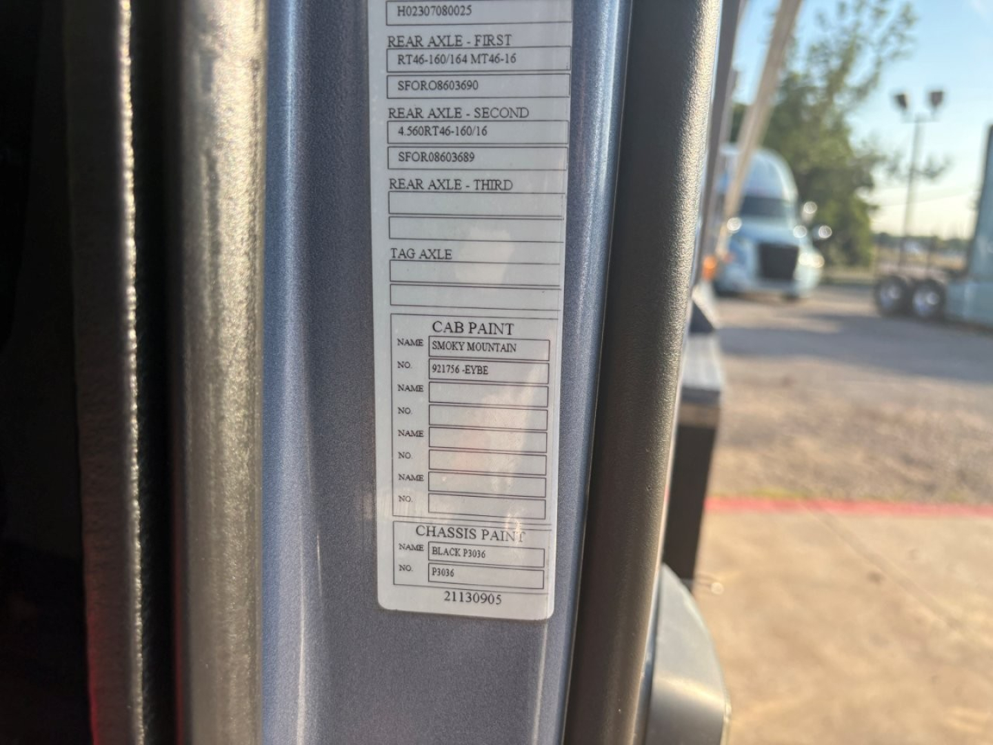 Cab label showing axle weights and paint codes on Volvo truck door jamb. Visible lines include rear axle first, second, third weights and cab paint and chassis paint fields.