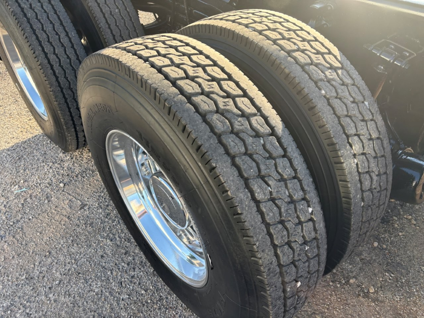 Dual rear tires on a Volvo VHD truck with polished rims and tread pattern visible.