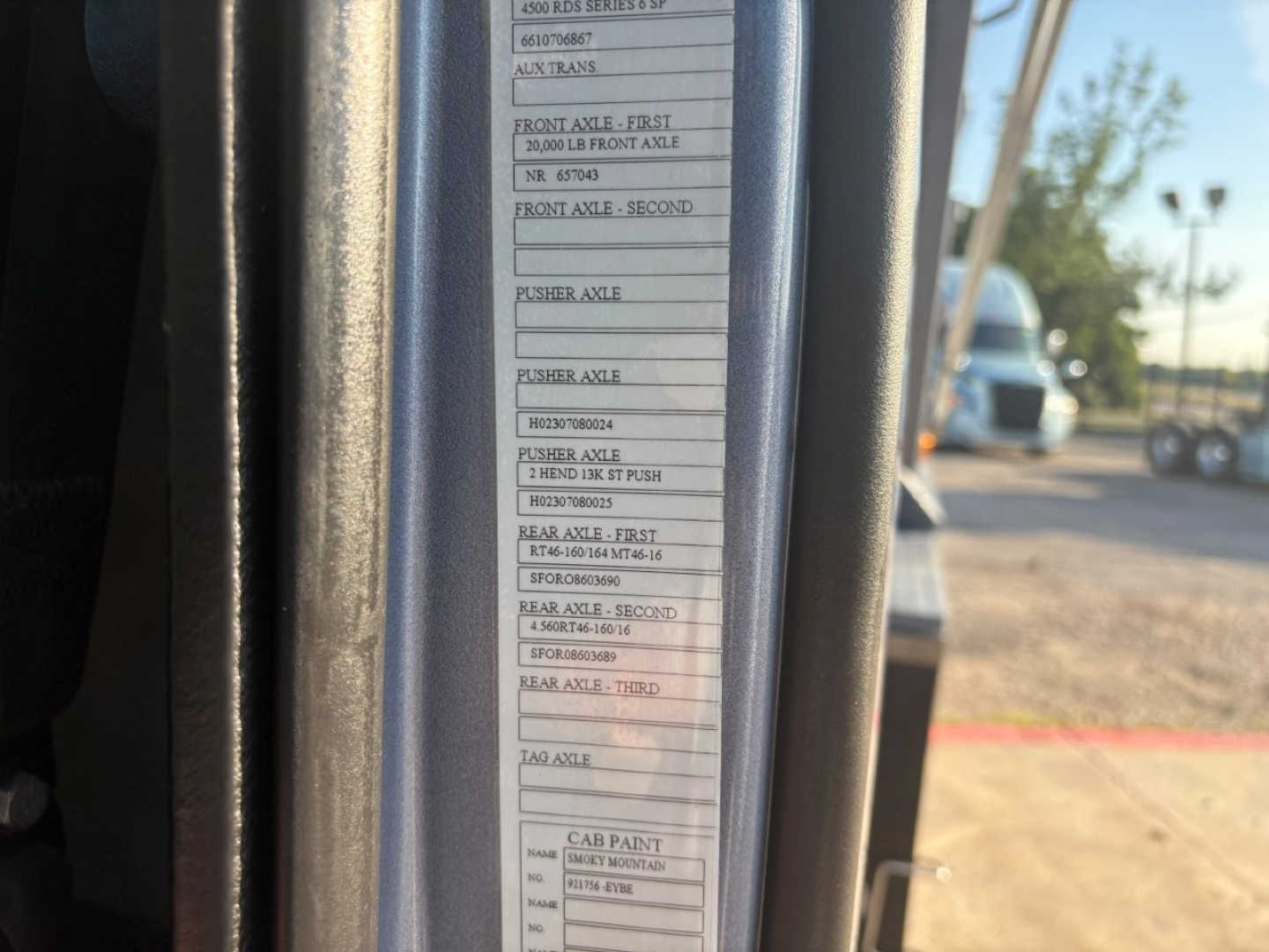 Label/sticker inside Volvo VHD cab door jamb listing axle specifications and capacities such as front axle first 20,000 lb front axle, rear axle etc. with multiple rows of small text and a barcode area.