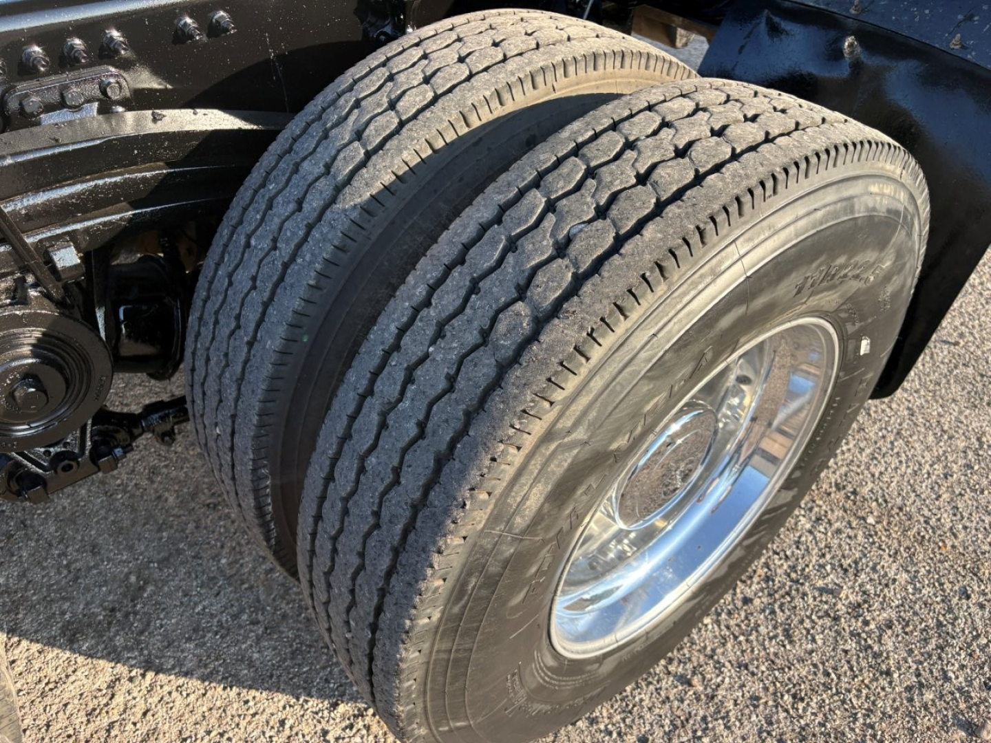 Volvo VHD104F300 truck front dual wheels showing tire tread and chrome wheel with black chassis