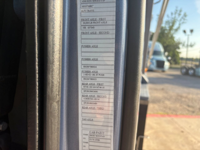 Label/sticker inside Volvo VHD cab door jamb listing axle specifications and capacities such as front axle first 20,000 lb front axle, rear axle etc. with multiple rows of small text and a barcode area.