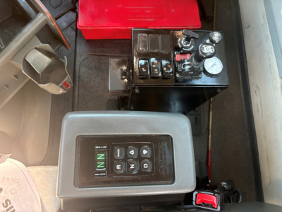 Gear selector and battery/controls inside Volvo VHD104F300 cab showing control panel with N and R gear indicator and switches.