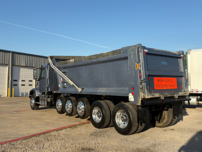Volvo VHD104F300 dump truck in-service showing rear and multiple axles with large metal dump bed.