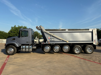 Volvo VHD104F300 dump truck side view showing dump body, multiple axles, and hydraulic lift system.